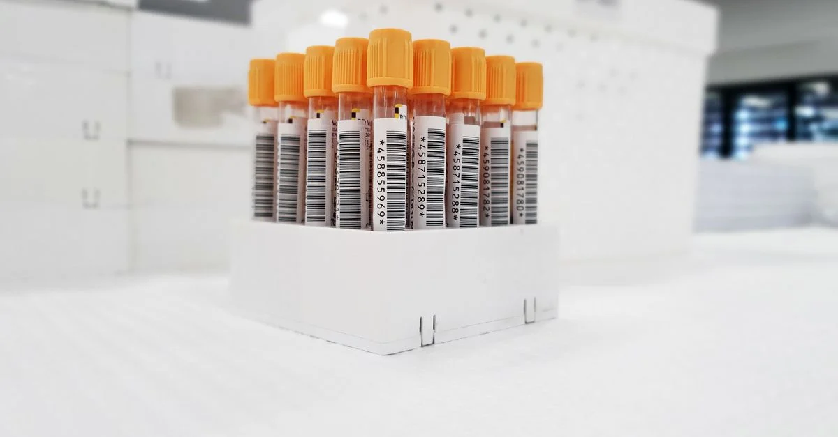 Tubes à essai d'échantillons de sang avec des codes-barres organisés dans un environnement de laboratoire.
