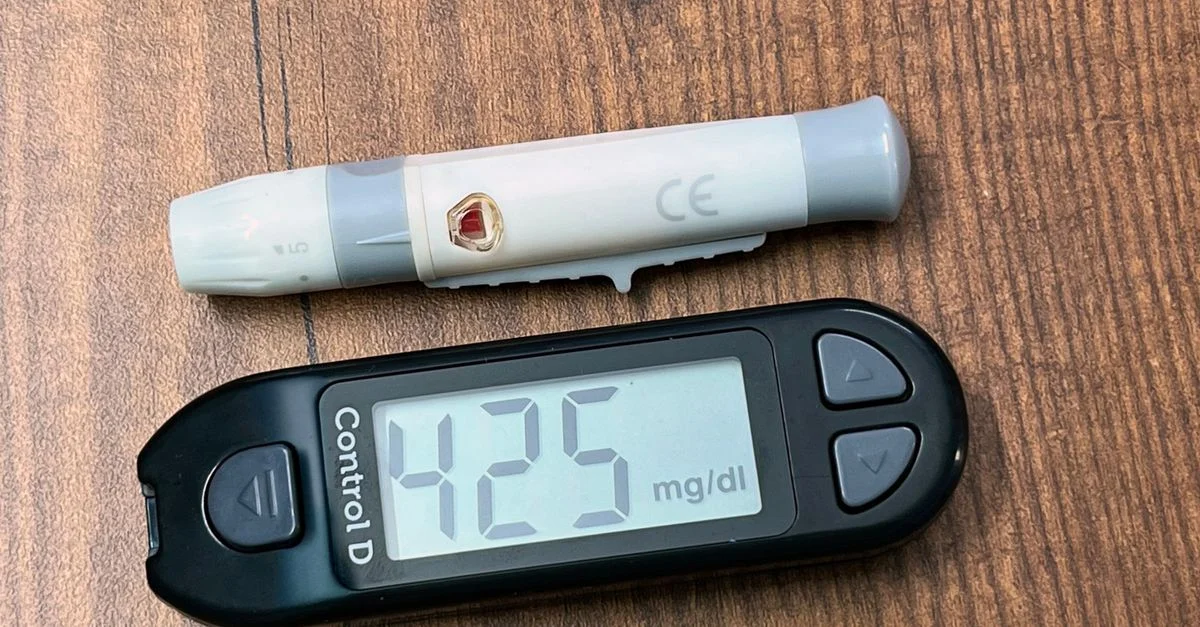 Un glucomètre affichant une lecture de glucose élevée de 425 mg/dL, essentiel pour les soins du diabète.